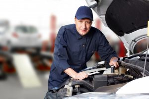 man repairing automatic transmission