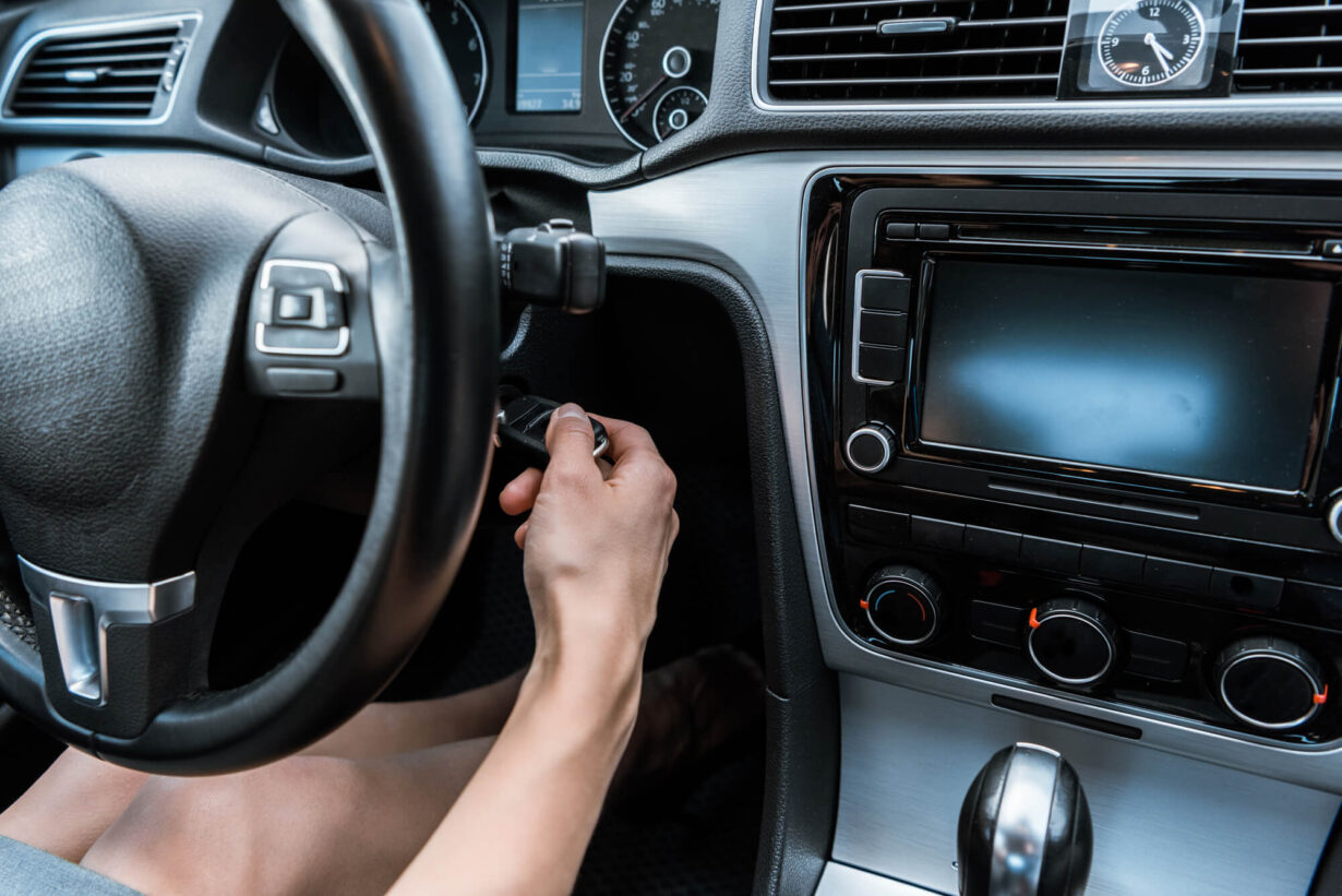 Woman making sure her cars automatic transmission is being maintained while driving.