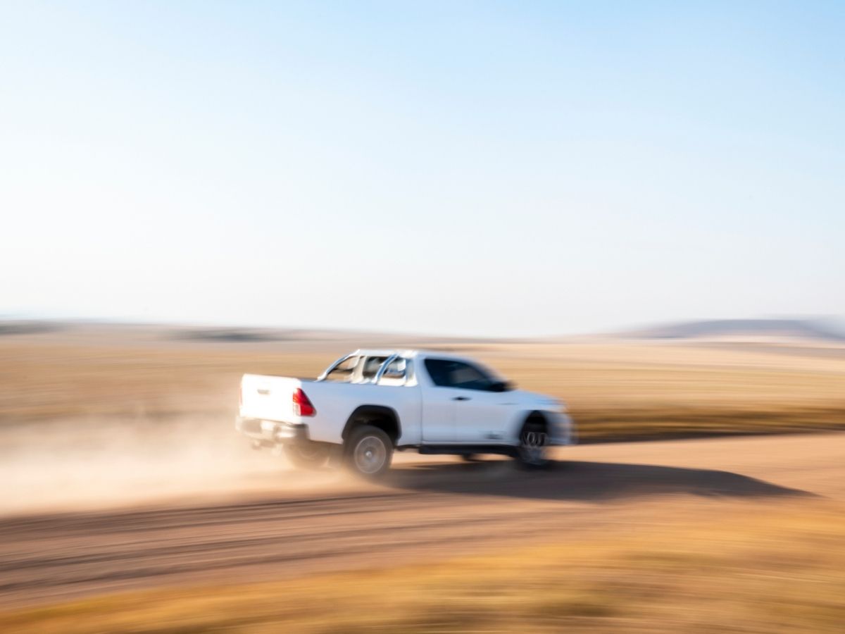 a toyota hilux driving in a wasteland
