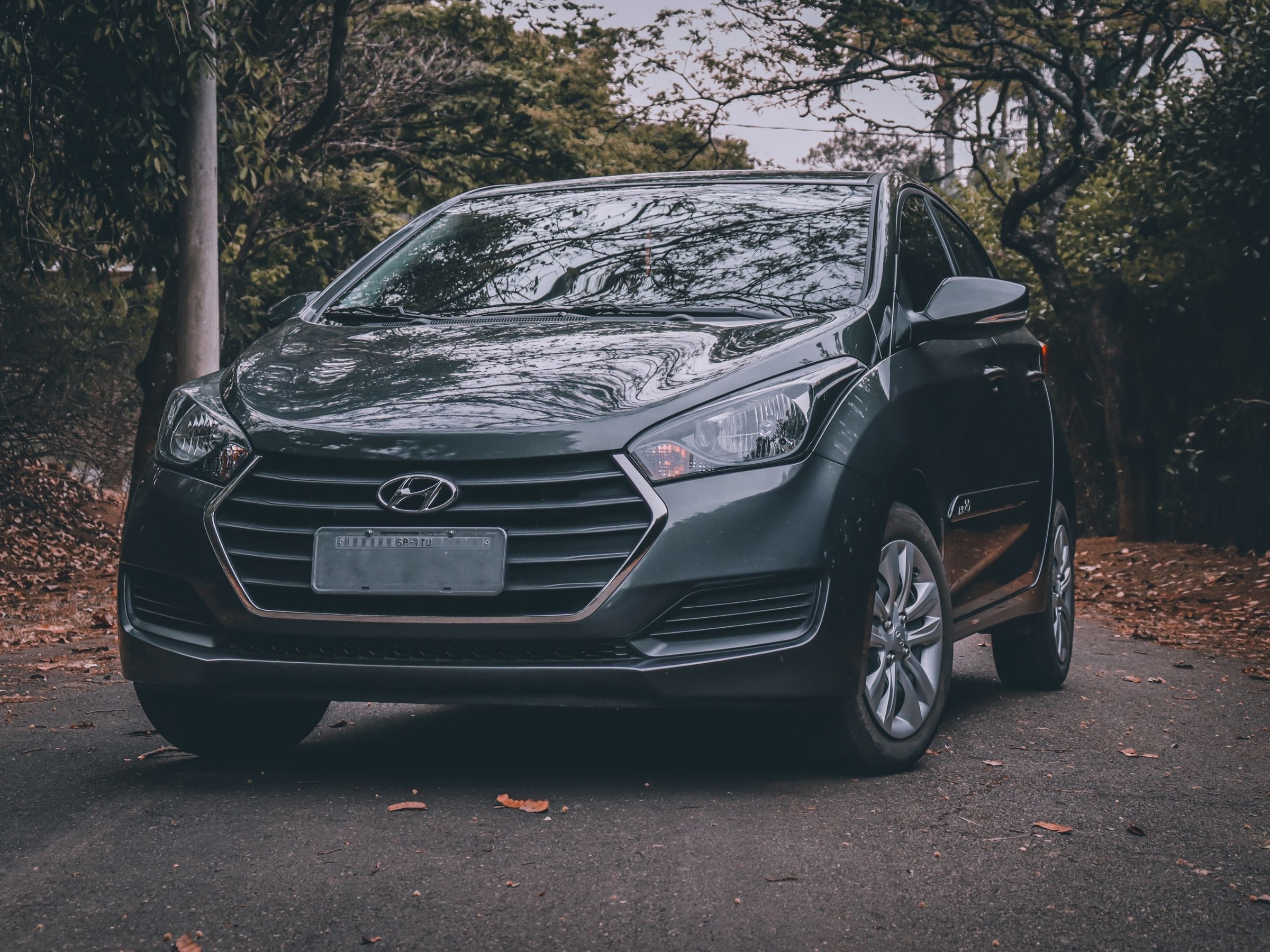Hyundai hatchback on a suburban road used in a guide about Hyundai transmission reliability