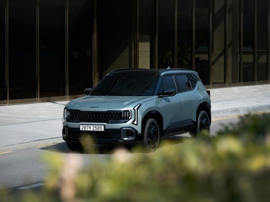 a Kia car driving on a main road