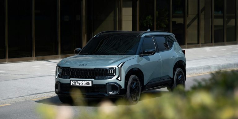 a Kia car driving on a main road
